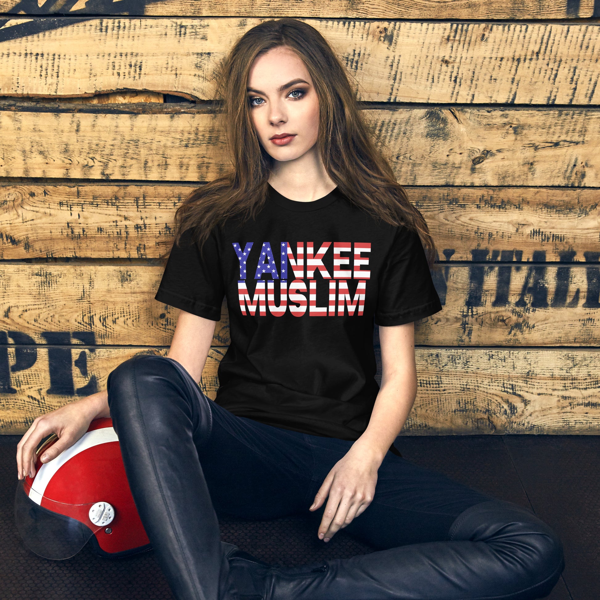 A black unisex t-shirt with the words ‘Yankee Muslim’ boldly printed in red, white, and blue—the iconic colors of the American flag.