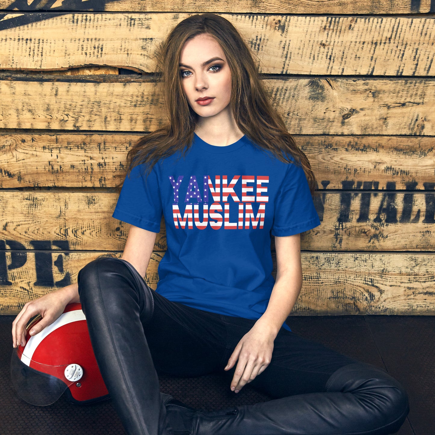 A blue unisex t-shirt with the words ‘Yankee Muslim’ boldly printed in red, white, and blue—the iconic colors of the American flag.