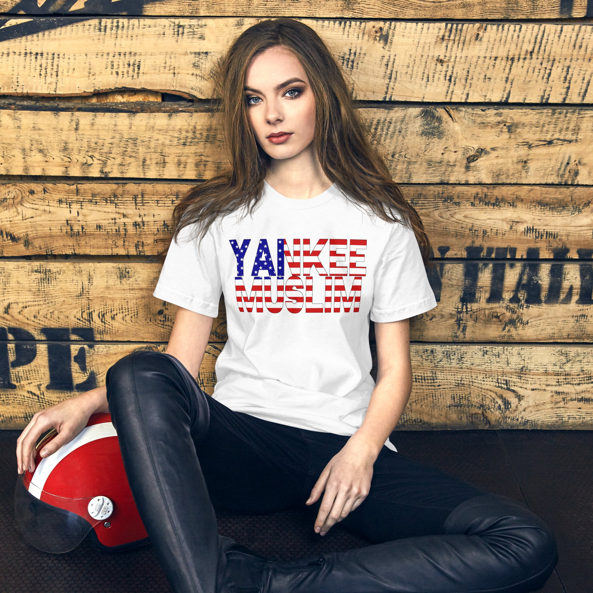 A white unisex t-shirt with the words ‘Yankee Muslim’ boldly printed in red, white, and blue—the iconic colors of the American flag.